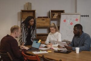 woman in black and white striped long sleeve shirt sitting beside woman in white long sleeve