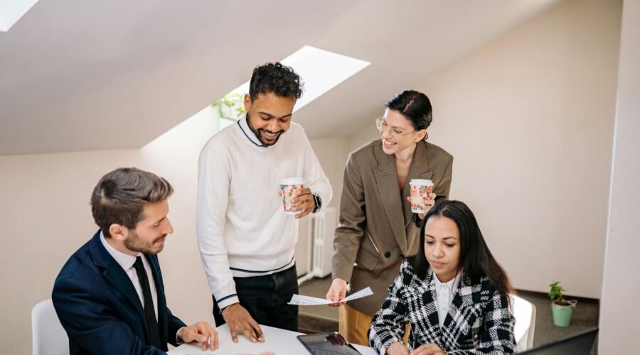 smiling colleagues araound table at office